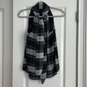 Sleeveless, tartan top with tie in back.